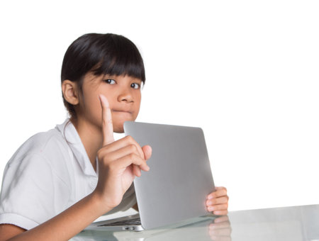 Young Asian school girl protecting hiding her computer screen