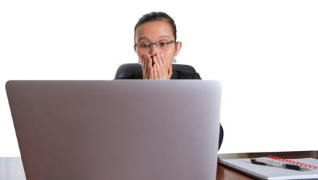 Asian businesswoman at her office desk over white background