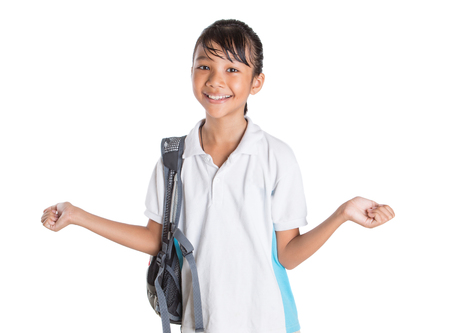 Young Asian school girl with backpack in school uniform over white backgroundの写真素材