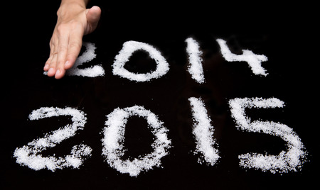 Female hands wiping Year 2014 leaving Year 2015 の写真素材