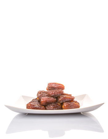 Date fruits on a white plate