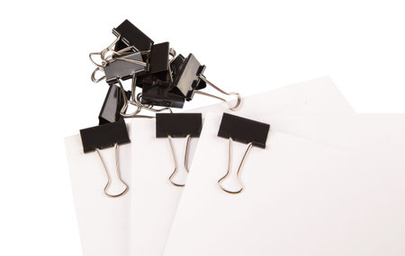 Binder clips with black white paper over white backgroundの写真素材