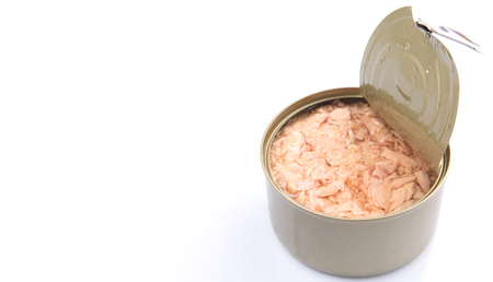Pieces of tuna fish in a tin can over white backgroundの写真素材