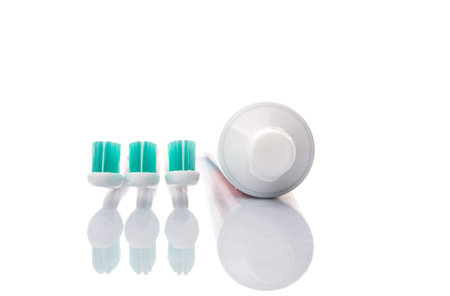 Toothbrush and toothpaste over white background