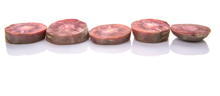 Chopped purple carrot over white backgroundの写真素材