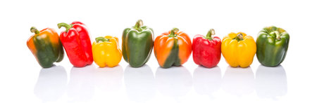 A group of different colors of capsicum over white background