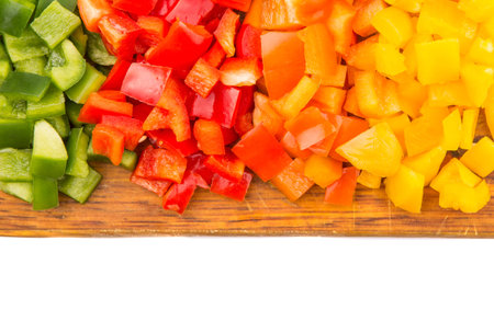 Colorful chopped capsicums wooden cutting board の写真素材