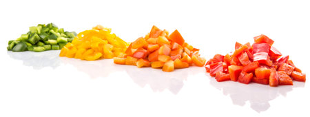 Heaps of chopped colorful capsicums over white backgroundの写真素材