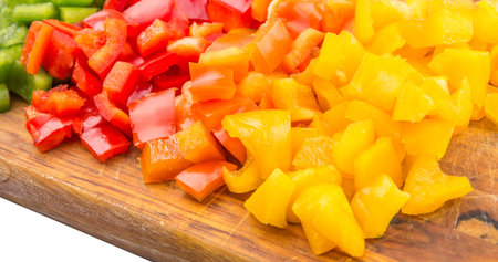 Colorful chopped capsicums wooden cutting board の写真素材