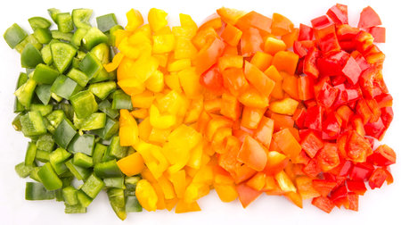 Chopped colorful capsicums over white backgroundの写真素材