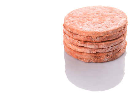 Frozen raw hamburger beef meat over white backgroundの写真素材
