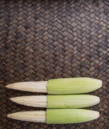 Baby corns over wicker backgroundの写真素材
