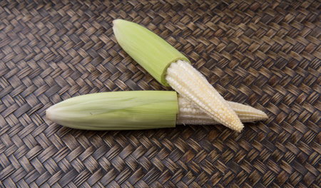 Baby corns over wicker background