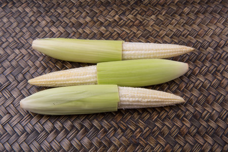 Baby corns over wicker background