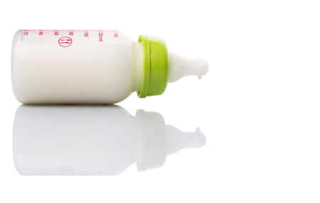 Milk in a baby bottle over white backgroundの写真素材