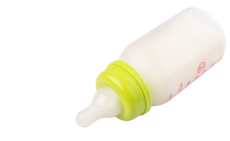 Milk in a baby bottle over white backgroundの写真素材