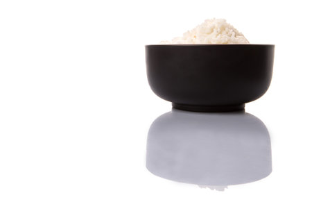 A bowl of rice over white background の写真素材