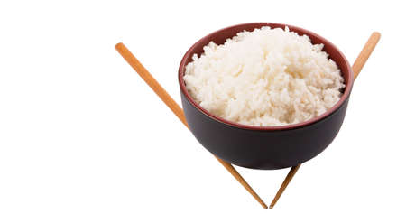 A bowl of rice and a pair of chopstick over white backgroundの写真素材