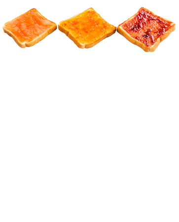 Mix fruit, blueberry, orange fruit jam spread on bread toast over white backgroundの写真素材