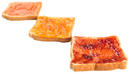 Mix fruit, blueberry, orange fruit jam spread on bread toast over white background