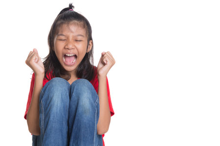 Stressed and screaming young Asian girl over white backgroundの写真素材