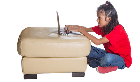 Young Asian girl with a laptop over white backgroundの写真素材