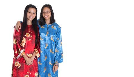 Asian Malay mother and daughter in traditional dress over white backgroundの写真素材