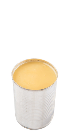 Condensed milk in tin can over white backgroundの写真素材