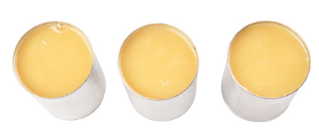 Condensed milk in tin can over white backgroundの写真素材