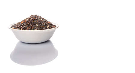 Black glutinous rice in a white bowl over white backgroundの写真素材