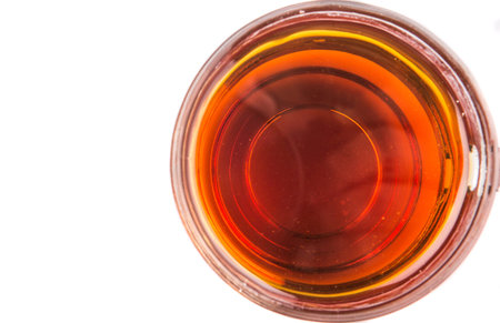 Honey in glass jar over white backgroundの写真素材