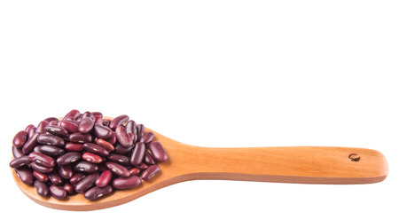 Red kidney beans on wooden spoon over white backgroundの写真素材