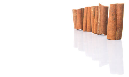 Cinnamon sticks over white backgroundの写真素材