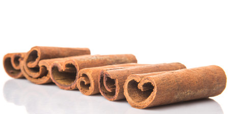 Cinnamon sticks over white background