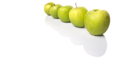 A group of green apples over white backgroundの写真素材