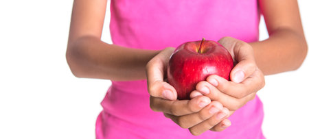 Girl hands holding a red apple over white backgroundの写真素材