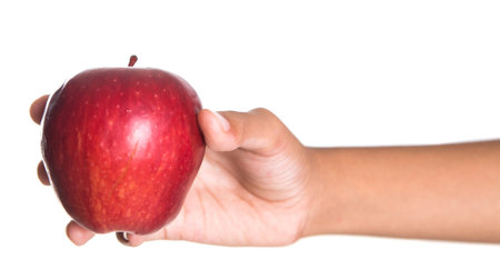Girl hands holding a red apple over white backgroundの写真素材