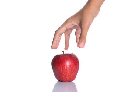 Girl hands holding a red apple over white backgroundの写真素材