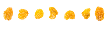 Golden colored dried raisin over white backgroundの写真素材