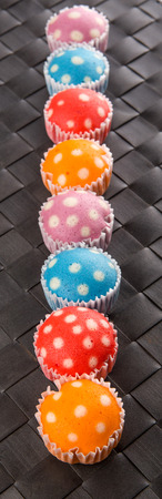 Popular Malaysian steamed rice polka dot muffin or apam polka dot on wicker backgroundの写真素材