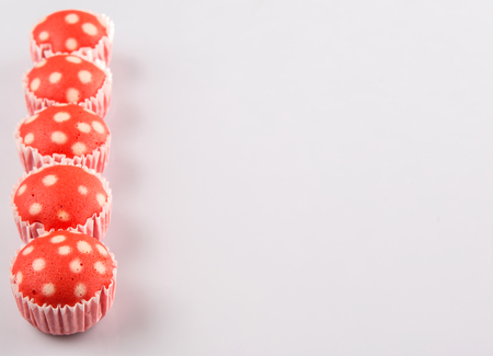 Malaysian red colored steamed rice polka dot muffin or apam polka dot on white backgroundの写真素材
