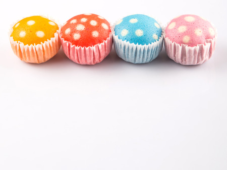 Malaysian colorful steamed rice polka dot muffin or apam polka dot on white backgroundの写真素材