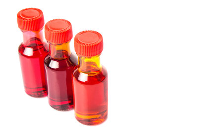 Liquid orange food color additive over white backgroundの写真素材