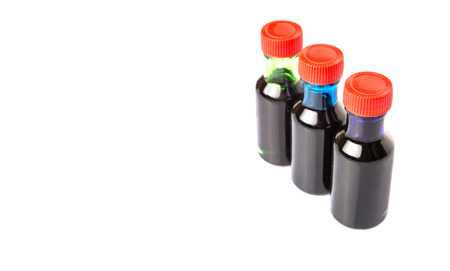 Different color variety of liquid food color additives over white backgroundの写真素材