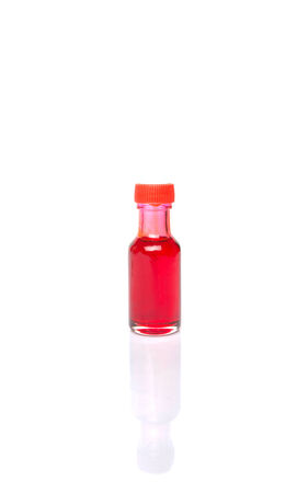 Liquid light red food color additive over white backgroundの写真素材
