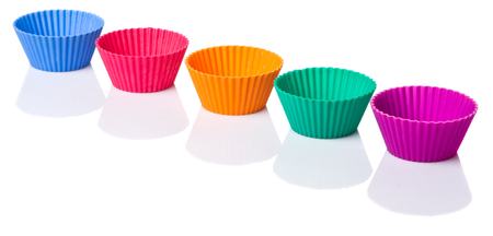 Various colors of silicone cupcake silicone baking cups over white backgroundの写真素材