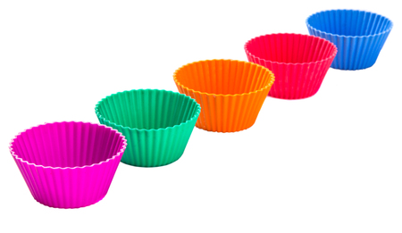 Various colors of silicone cupcake silicone baking cups over white backgroundの写真素材