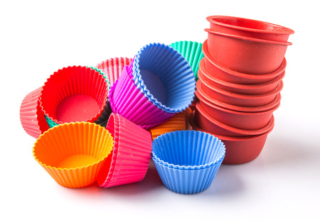 Various colors of silicone cupcake silicone baking cups over white backgroundの写真素材