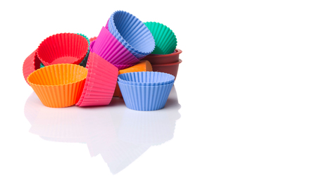 Various colors of silicone cupcake silicone baking cups over white backgroundの写真素材