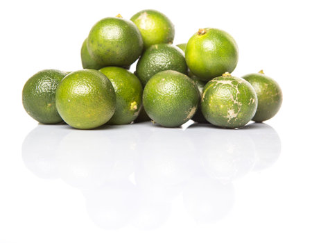 Calamondin or calamansi lime over white background